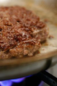Close-up of a smashed, well-browned burger patty.