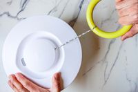 a person pulling on a salad spinner ring