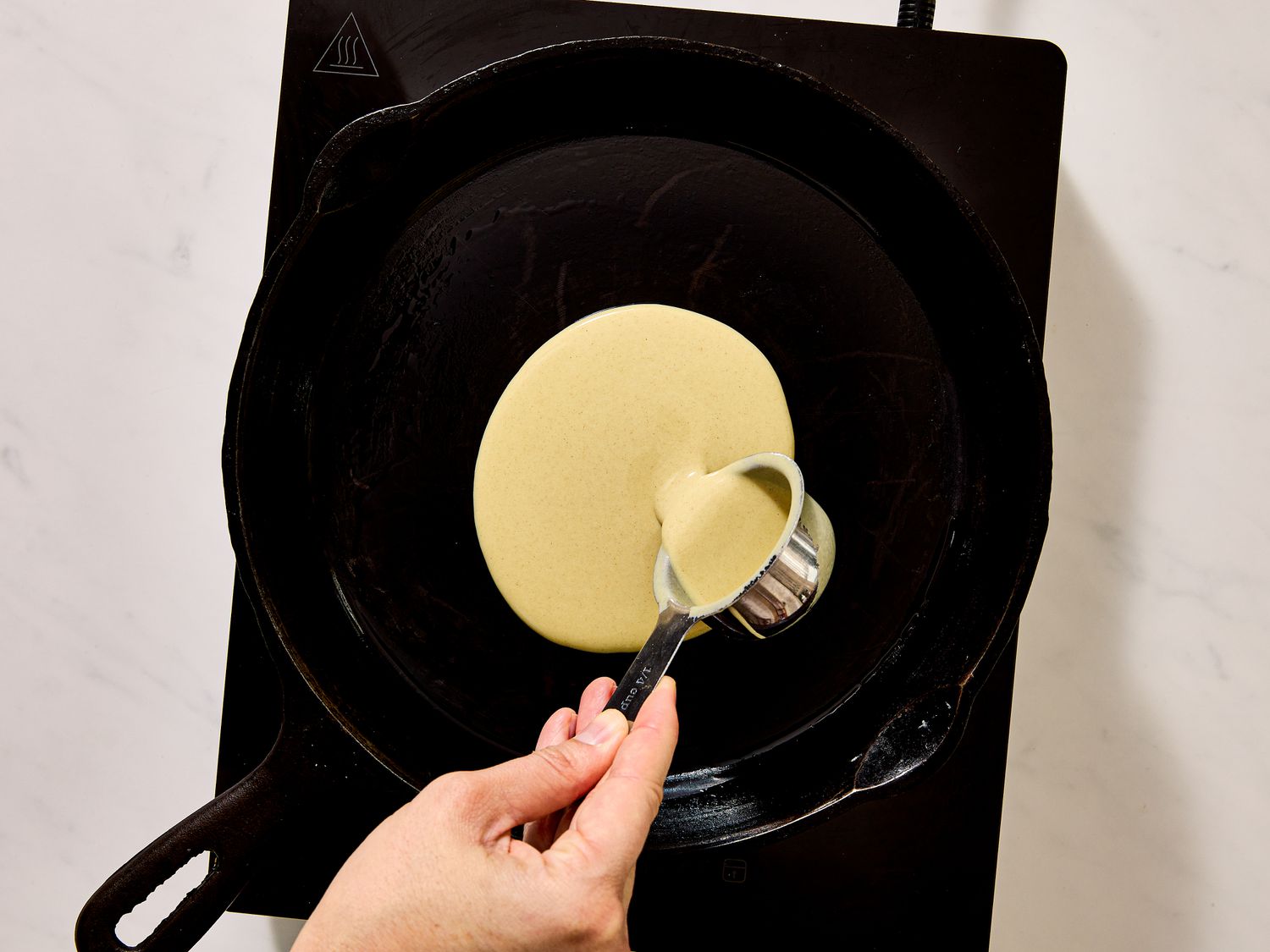 pouring batter on skillet 