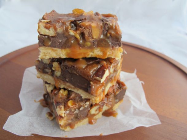 Closeup of a stack of gooey caramel twix bars.