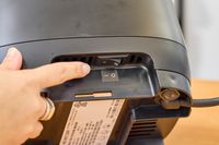 A finger pointing to a switch on the Vitamix Ascent X2