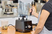 A person reoving the jar from the Vitamix Ascent X5 Blender base