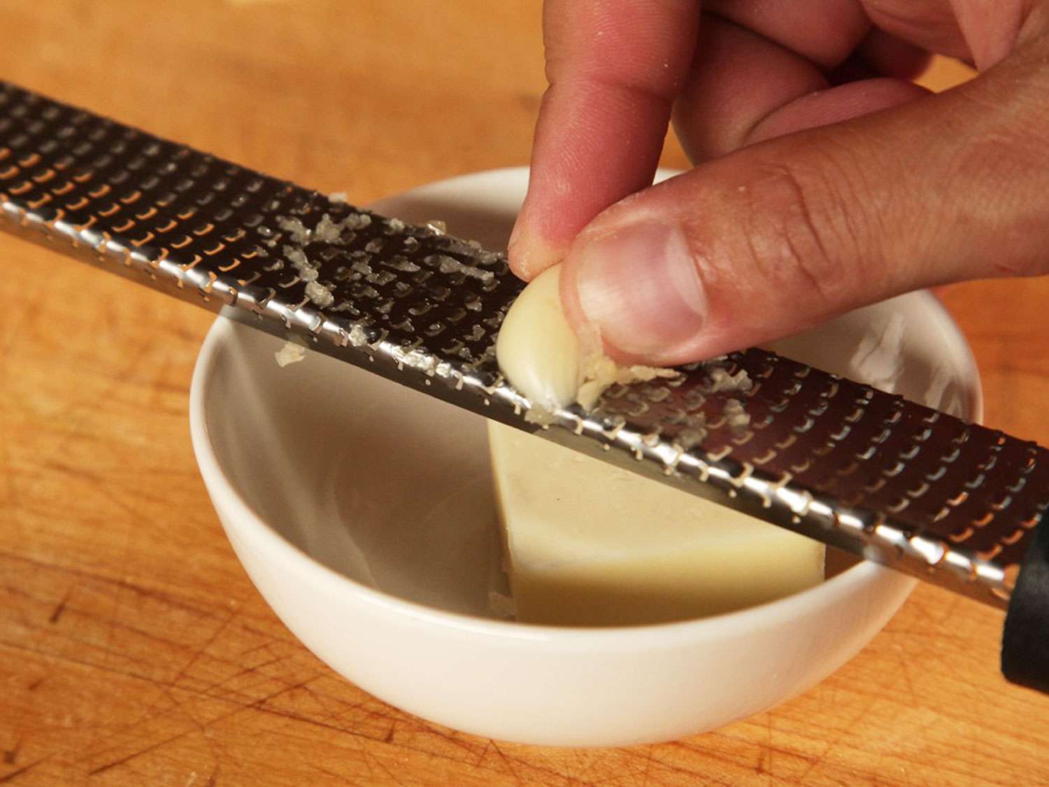 Grating garlic on a microplane.