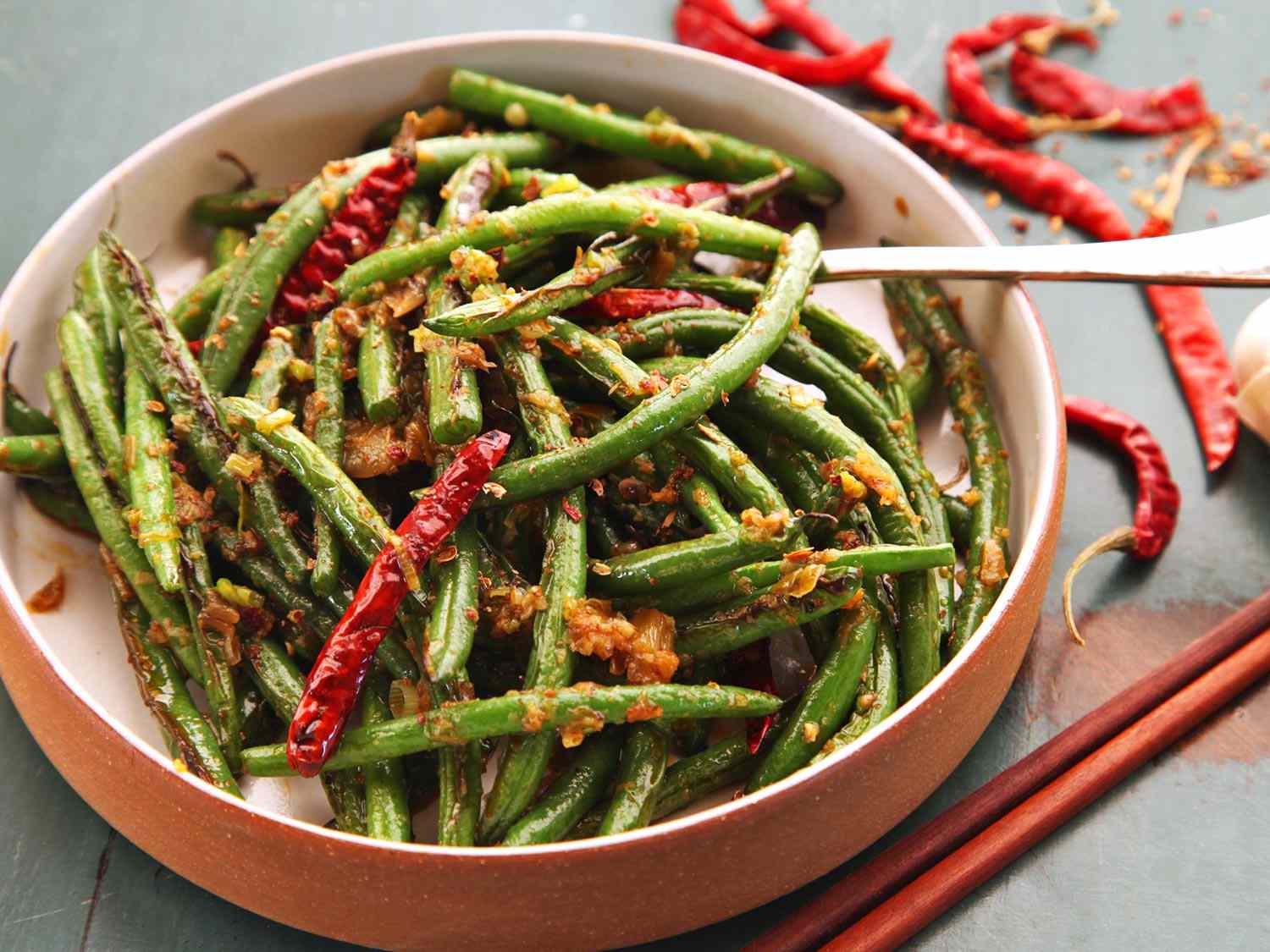 A serving bowl piled high with Sichuan dry-fried green beans.