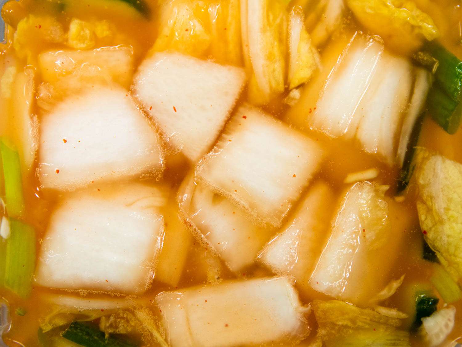 Water kimchi in its fermenting liquid.
