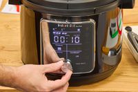 A person adjusts the knob of the Instant Pot Pro Plus Wi-Fi Smart 10-in-1 6-Quart Pressure Cooker