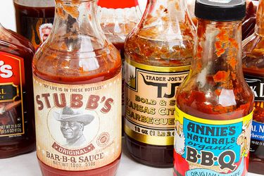 An assortment of bottled barbecue sauces on a table.