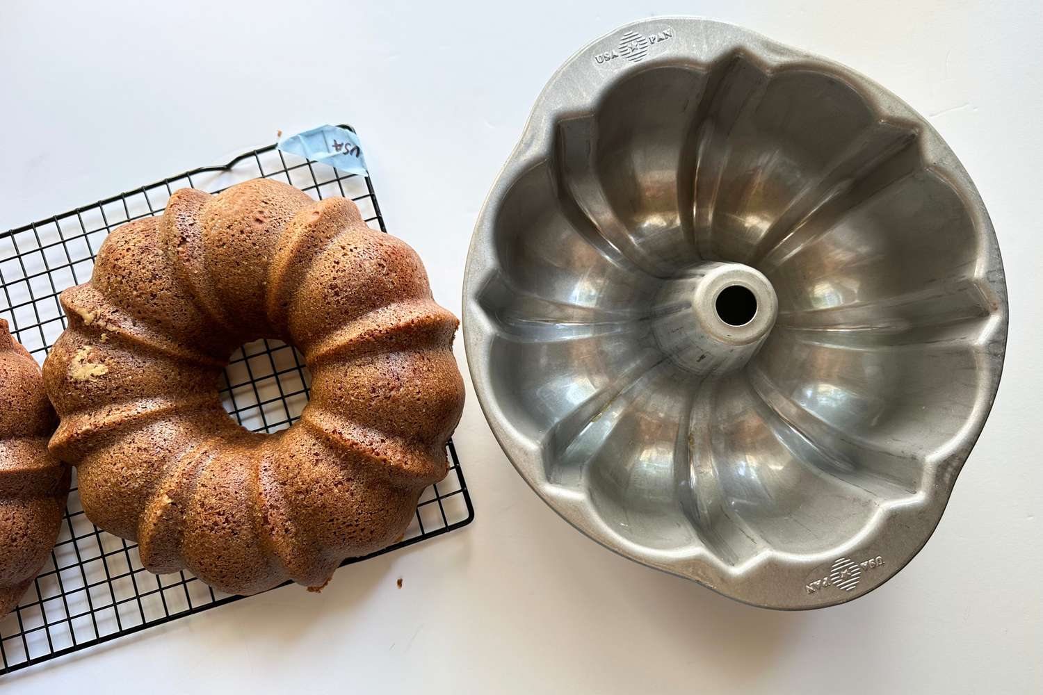 A USA Pan bundt pan next to a cake