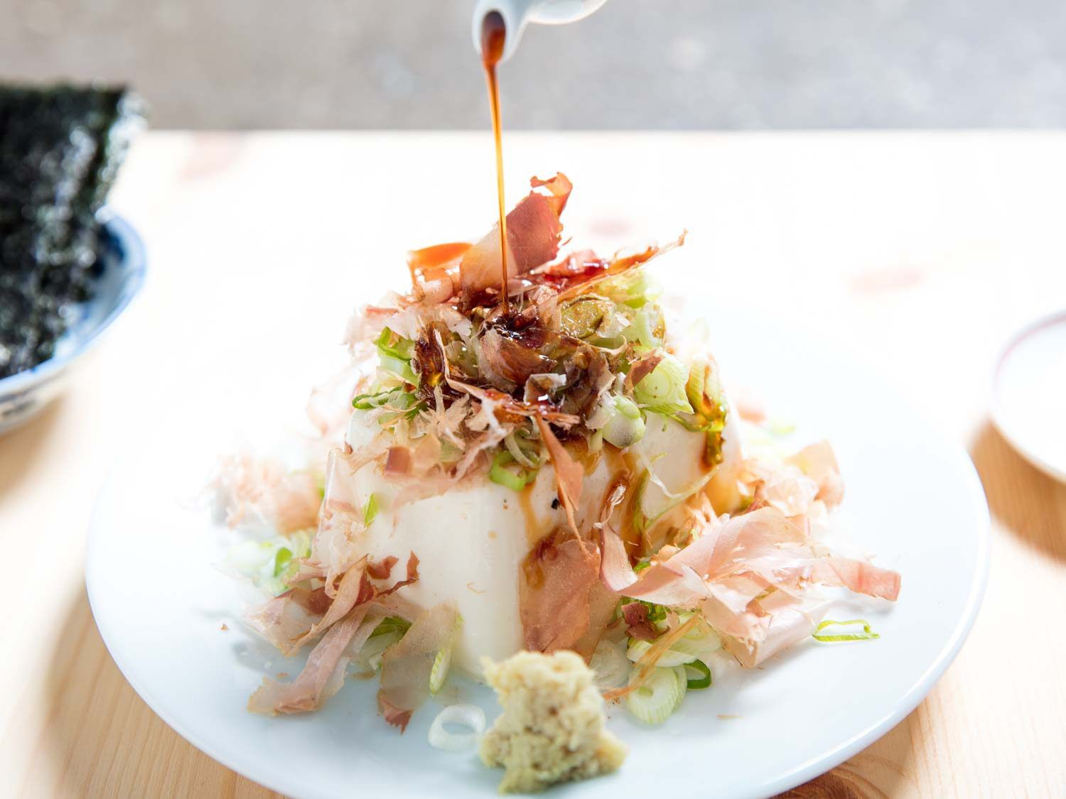 Tofu topped with scallions and bonito flakes