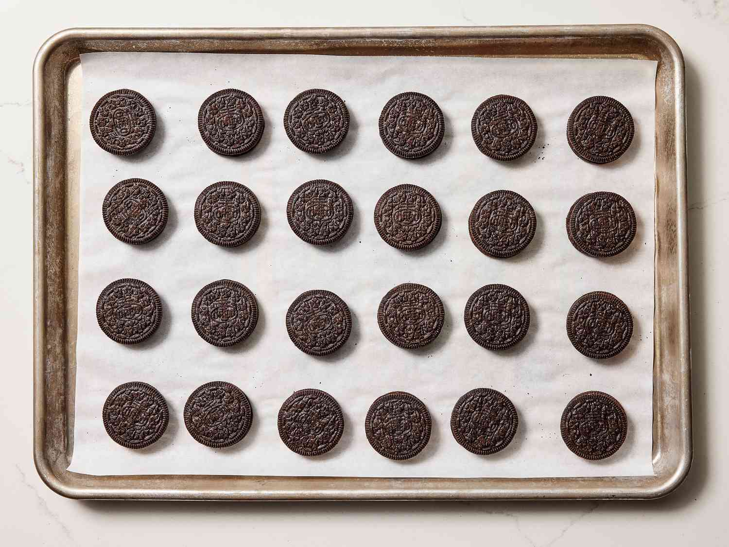 Frozen oreos lined up on a sheetpan 