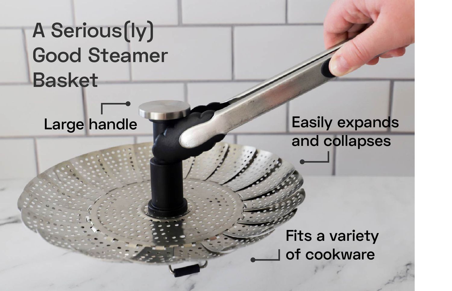 a hand picking up a steamer basket with a pair of tons