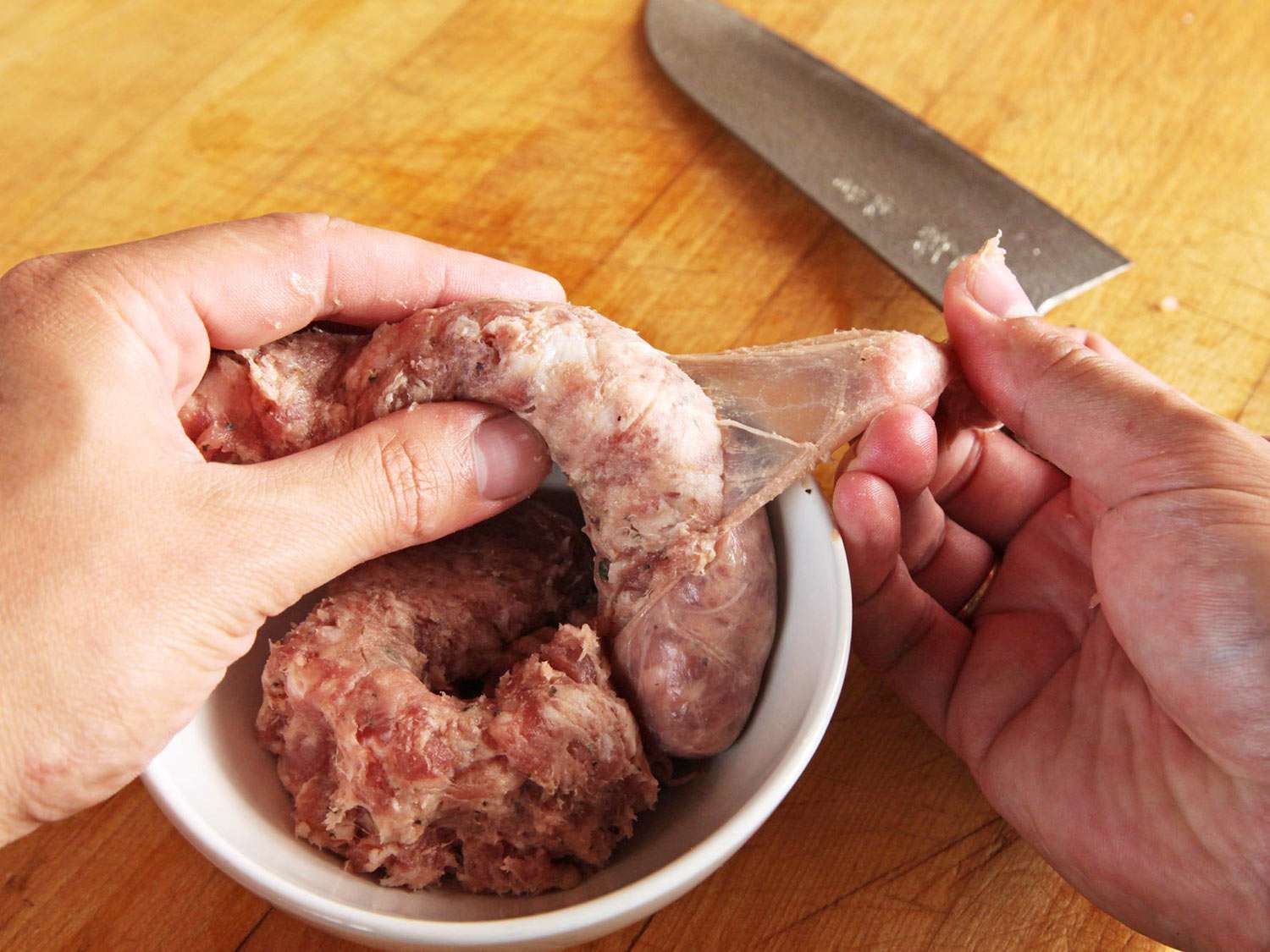 Removing casing from sausages.
