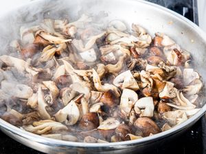 Sauting a variety of mushrooms in a pan