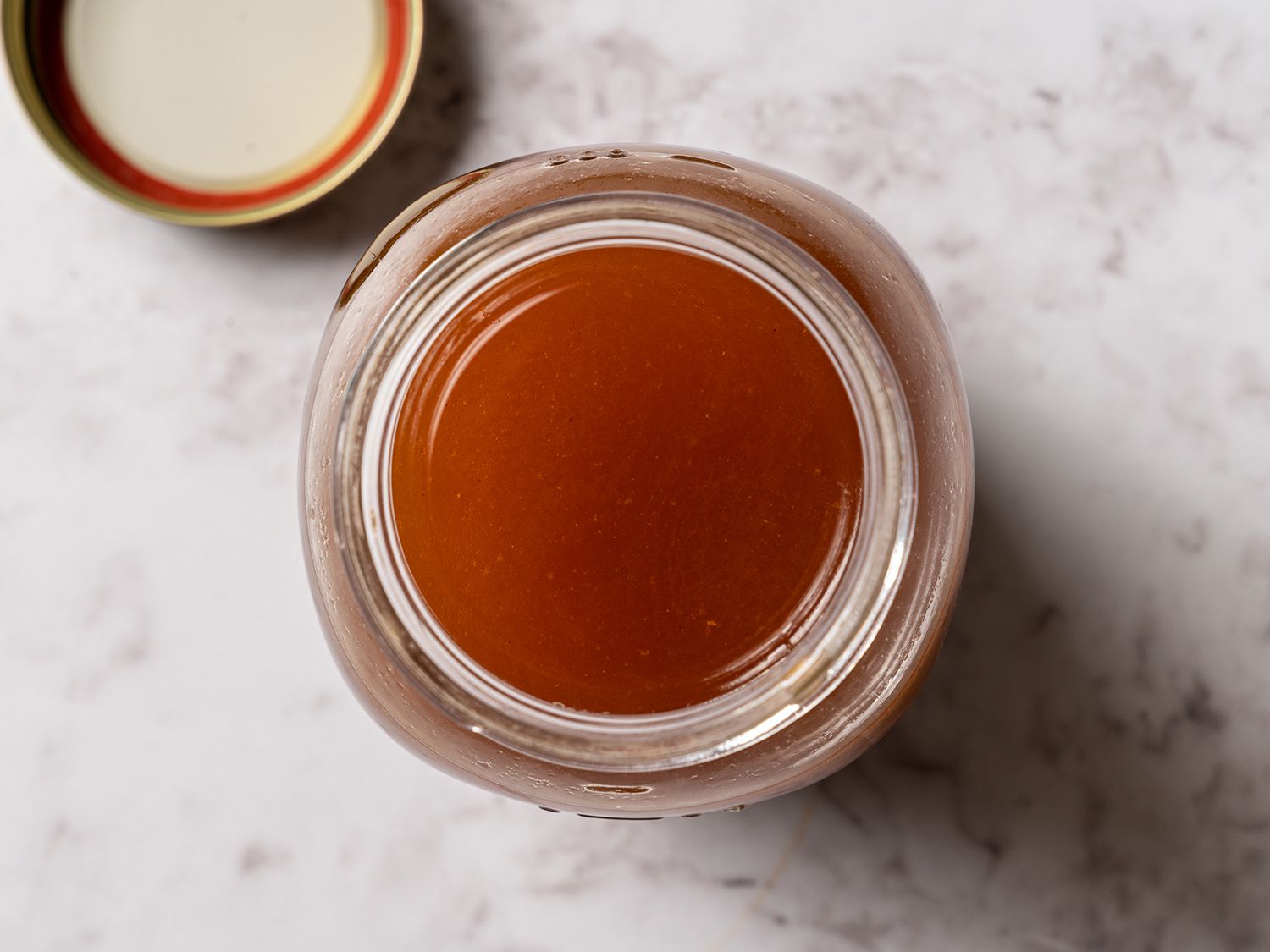 Overhead view of beef stock in a mason jar.