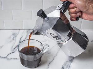 A person pouring coffee from the Bialetti Moka Espress