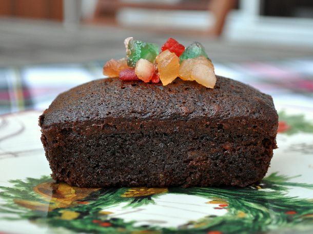Profile view of an individual spiced fruitcake, topped with extra candied fruit mix.