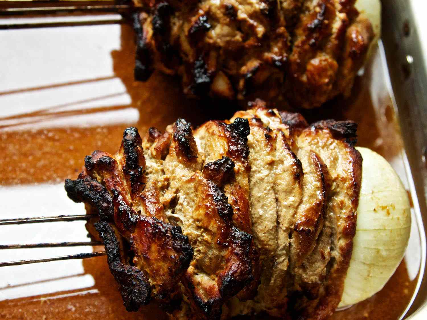Closeup of the finished skewers. The edges of the layers of meat are crispy and well-browned.