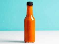 bright orange charred fresno and tamari fermented hot sauce in a bottle