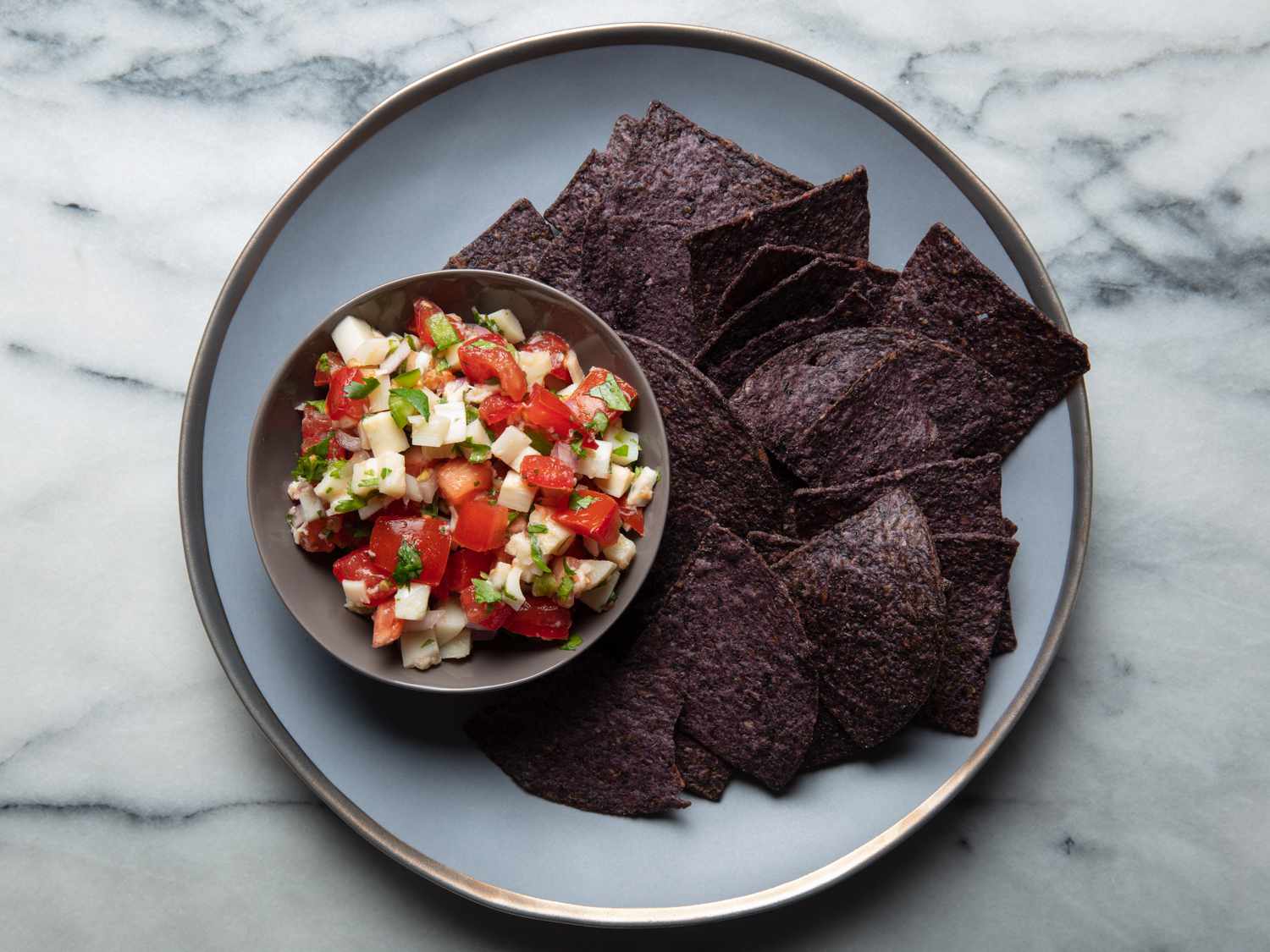Hearts of palm salsa on a plate with blue corn chips
