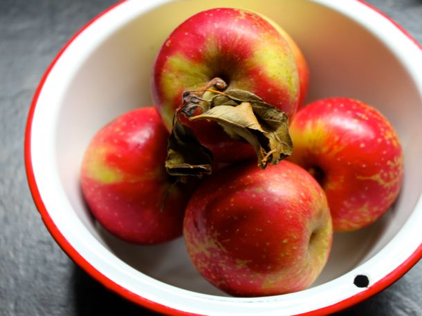 A bowl containing four apples. 