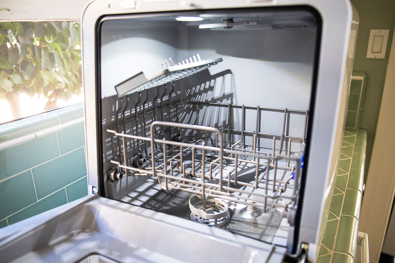 The Comfee countertop dishwasher with its door open.