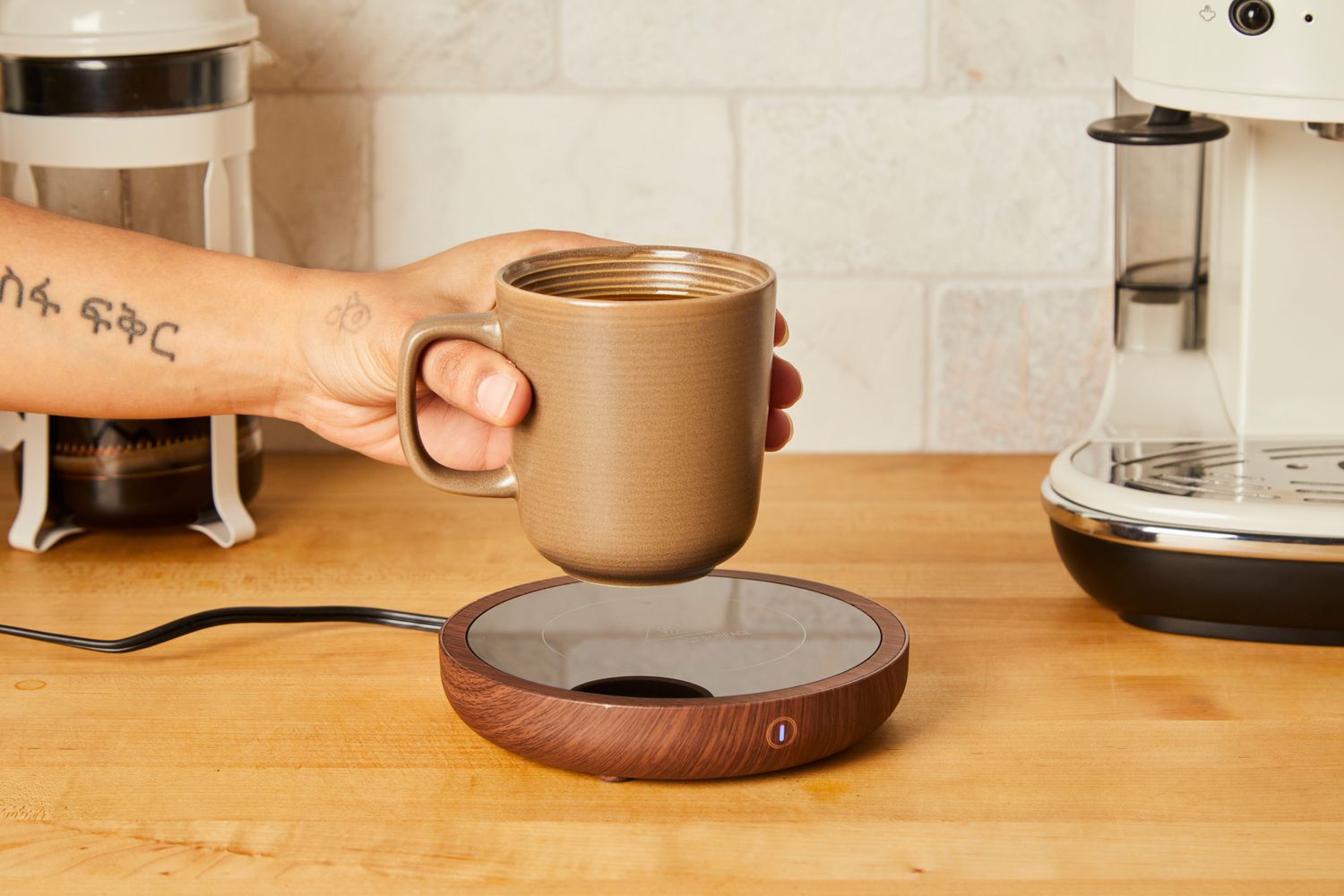 Person holding Sweetful Coffee Mug Warmer