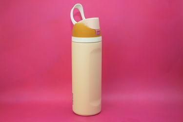 the owala water bottle on a pink surface